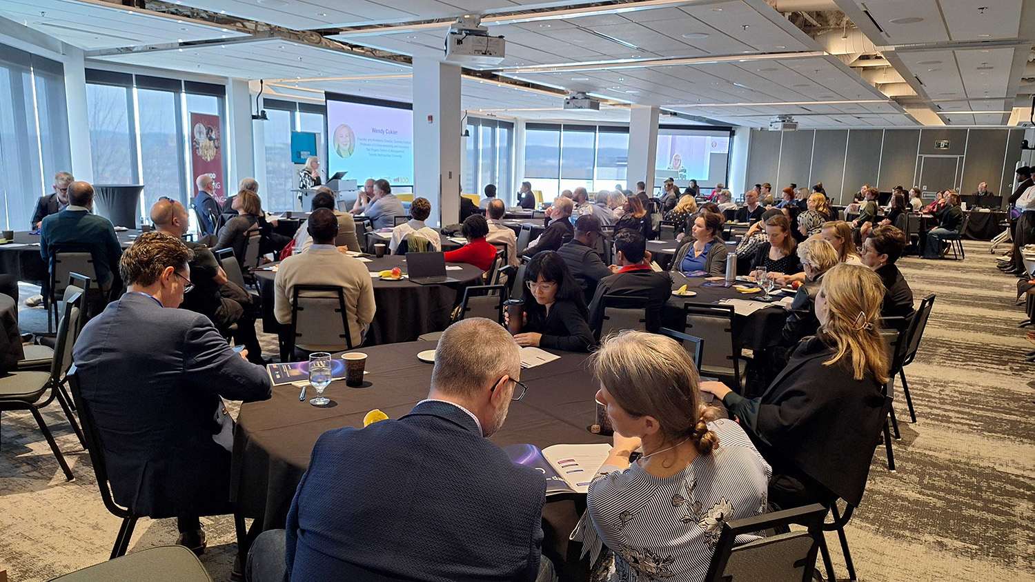 A large conference room filled with seated attendees facing the speaker at AI, Remote Work & Productivity: An International Conference in St. John’s.