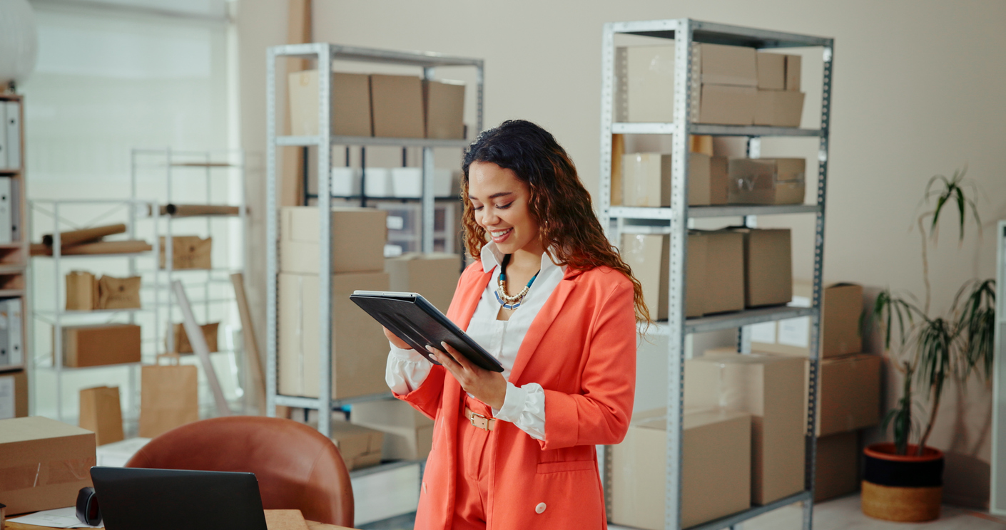 A woman utilizes technology in her office and workshop.