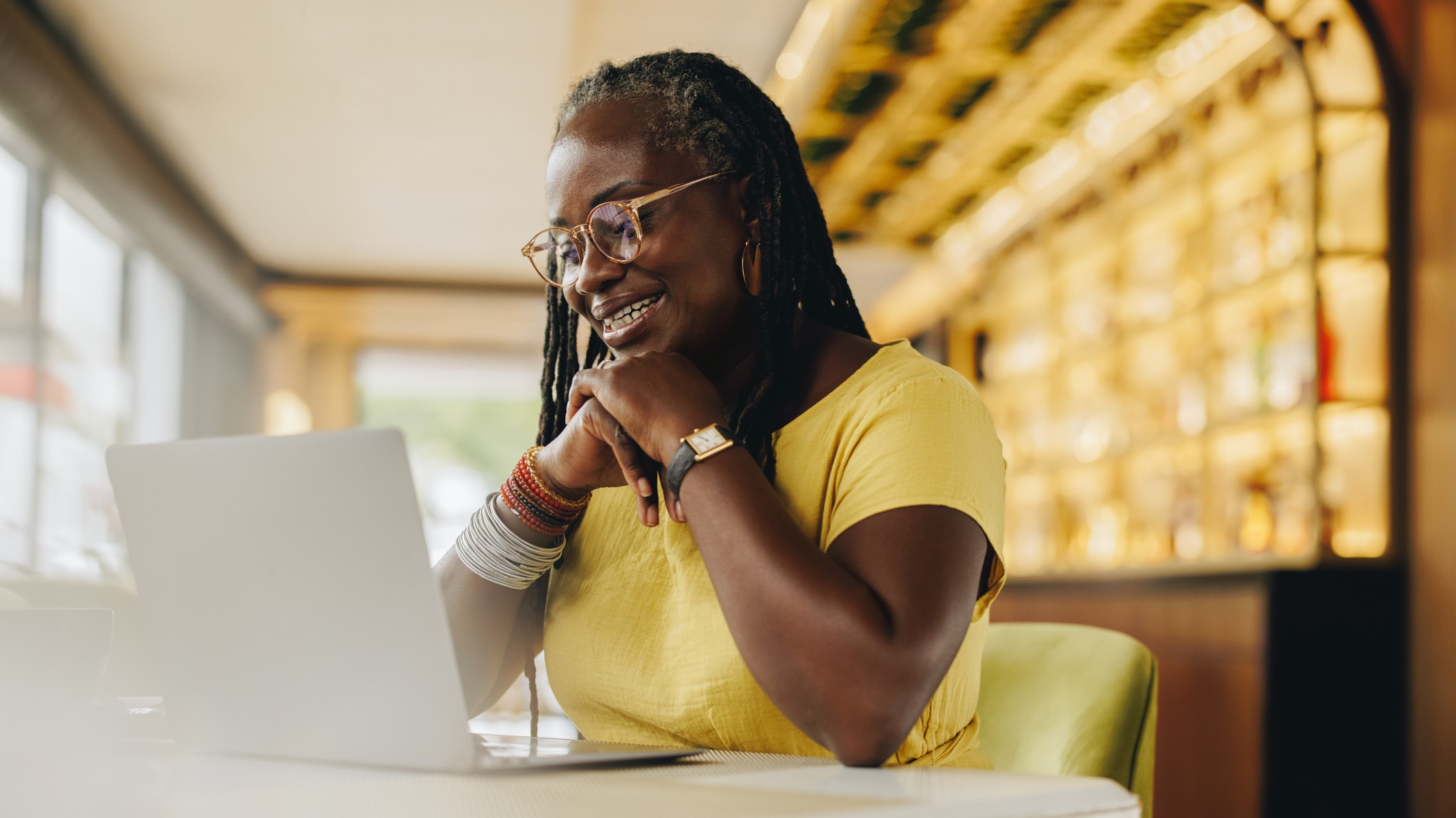 A mature woman is working on her laptop. 