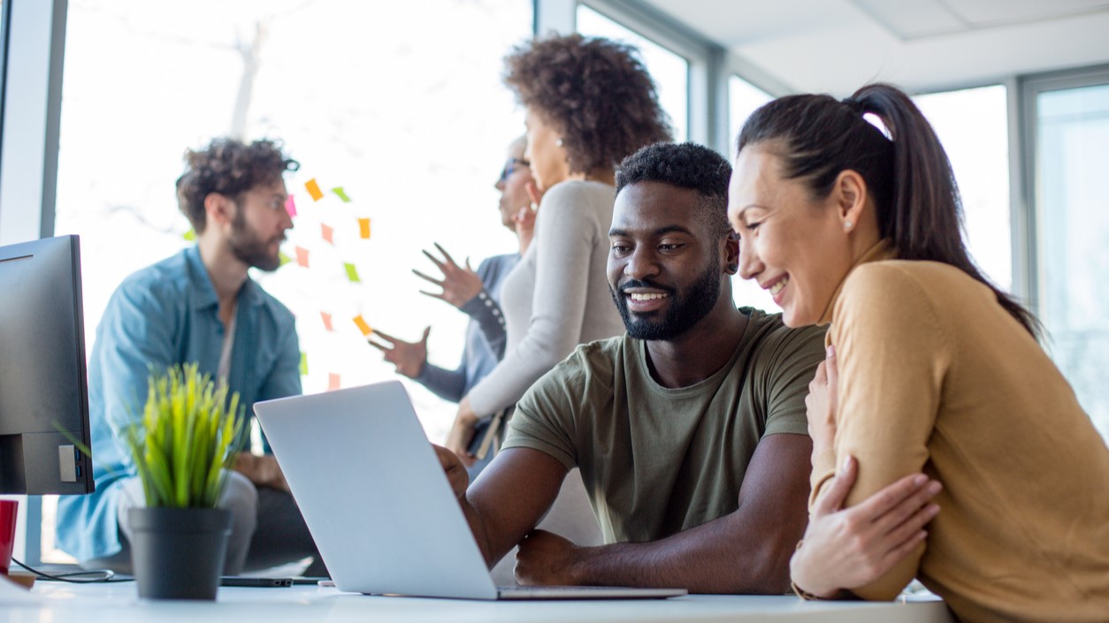 In an office, colleagues are working collaborativley. 