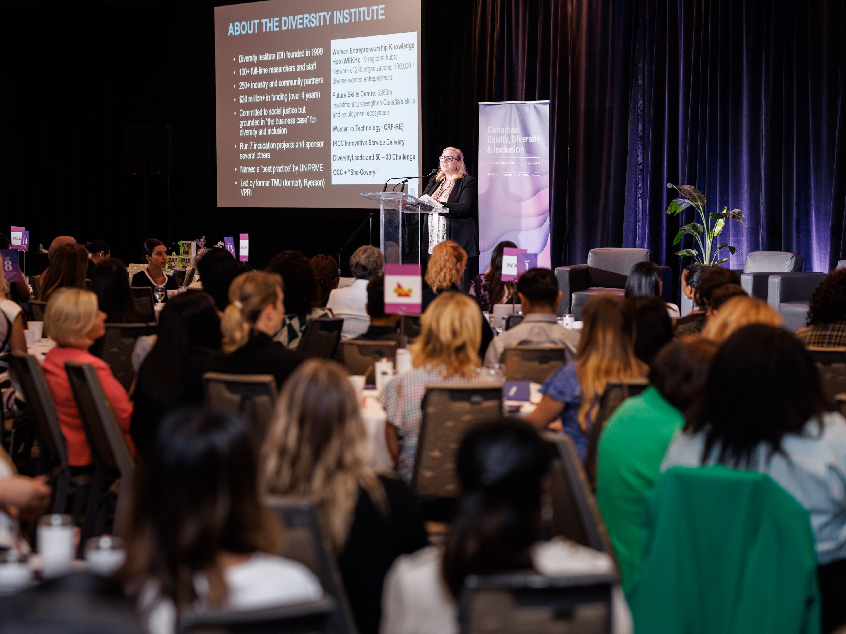  A woman is conducting a presentation on stage. 