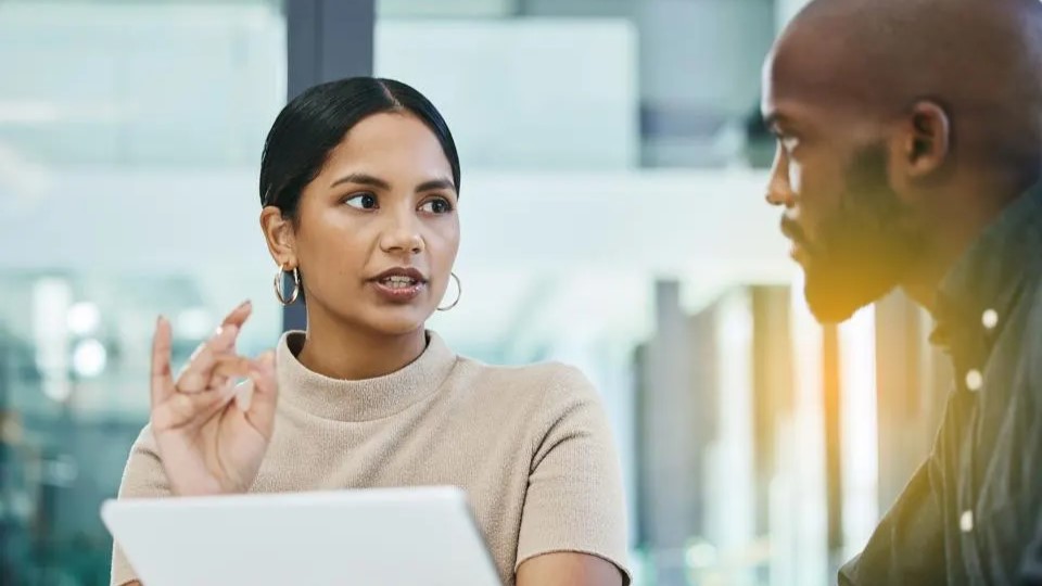 A woman and a man are conversing.