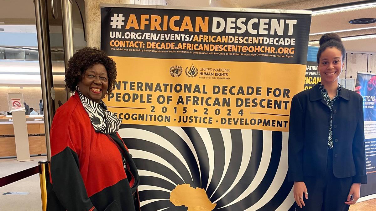 Three women smile and pose for a photo.