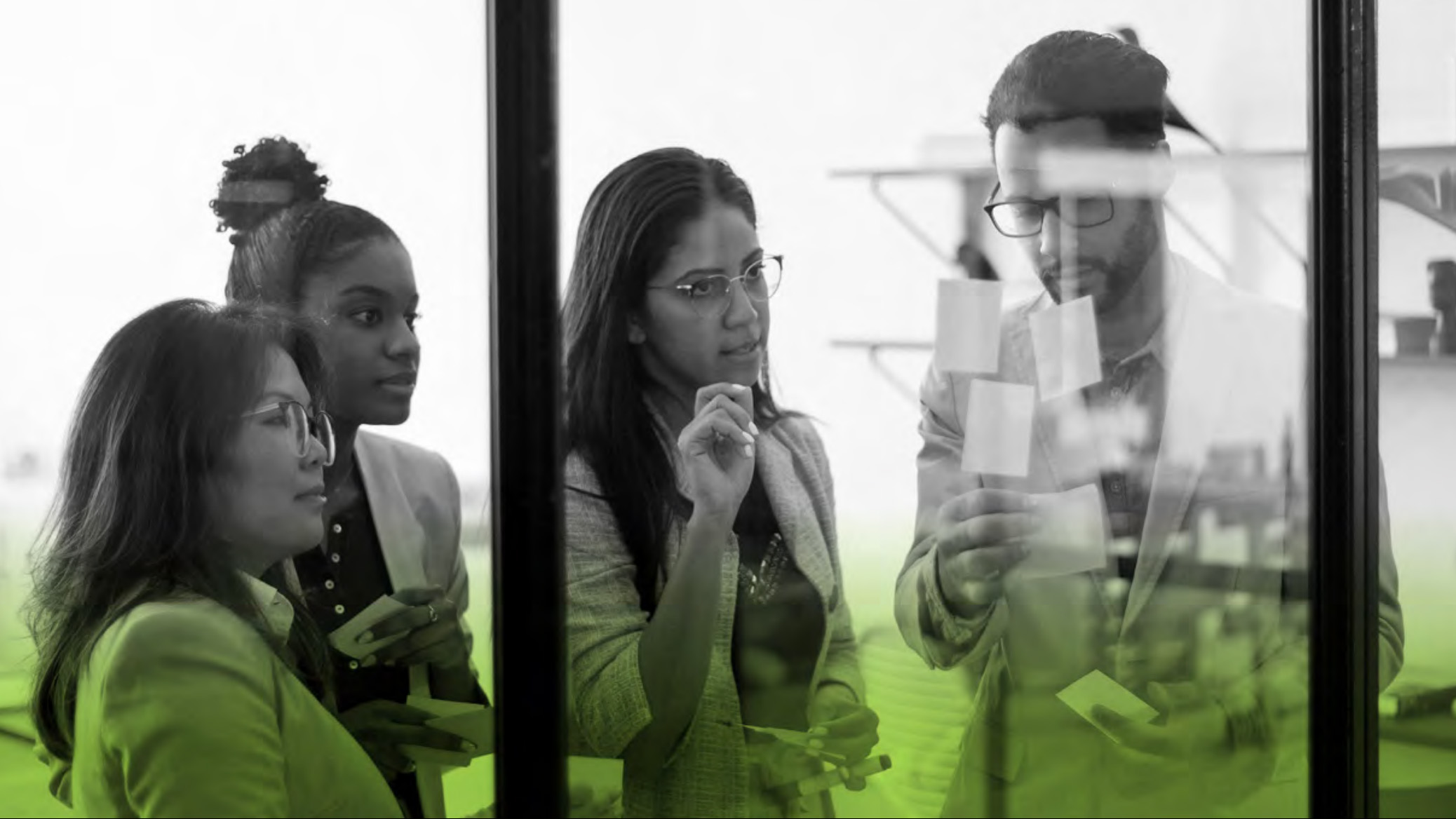 A group of four people focused and working collaborativley.