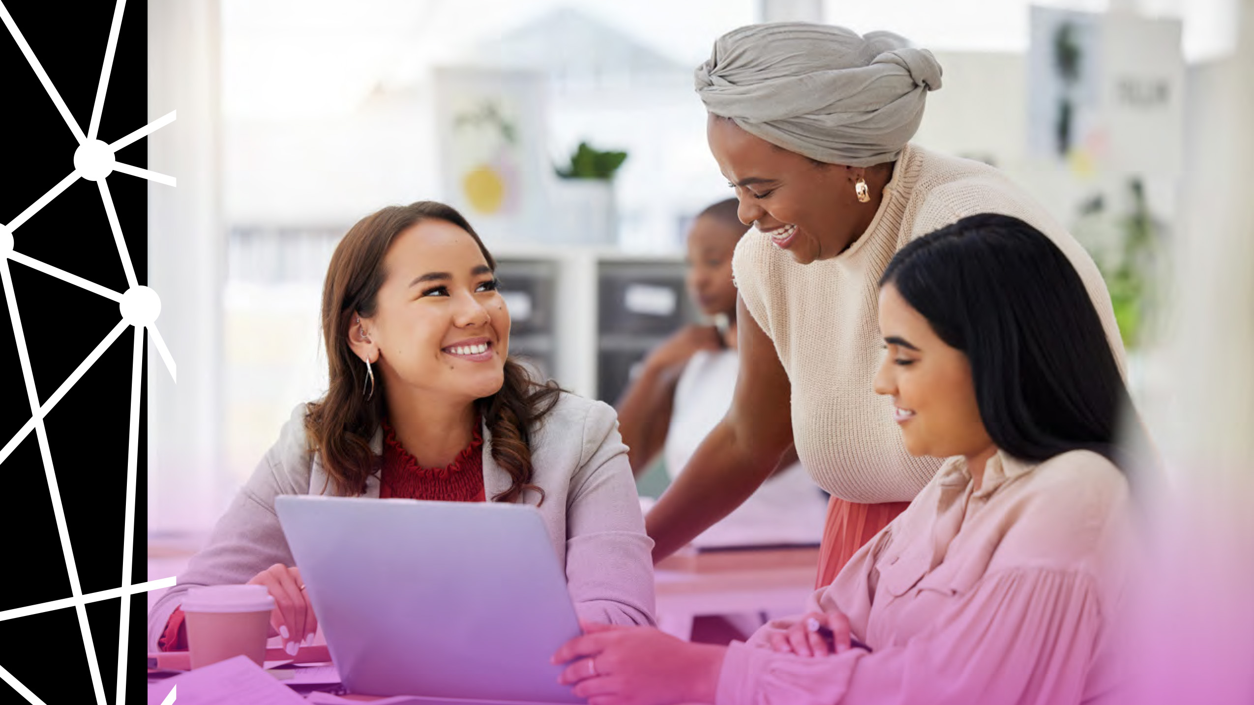 Three diverse women work collaborativley. 