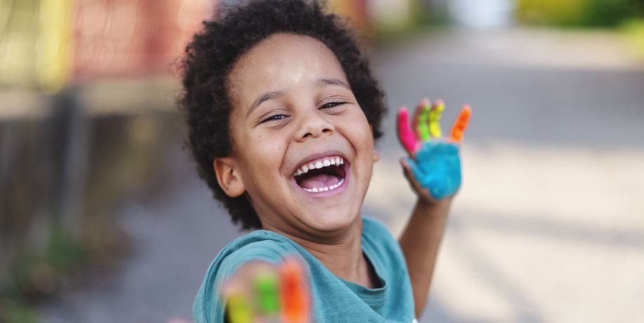 Happy boy with painted hands