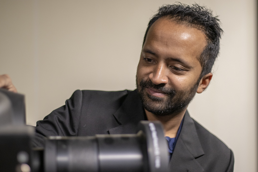 Professor Naimul Khan looks at a piece of equipment in the Ryerson Multimedia Research Laboratory.