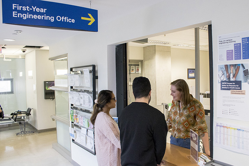 Two students at the First-Year Engineering Office speaking with a First-Year Engineering Office team member in the engineering building.