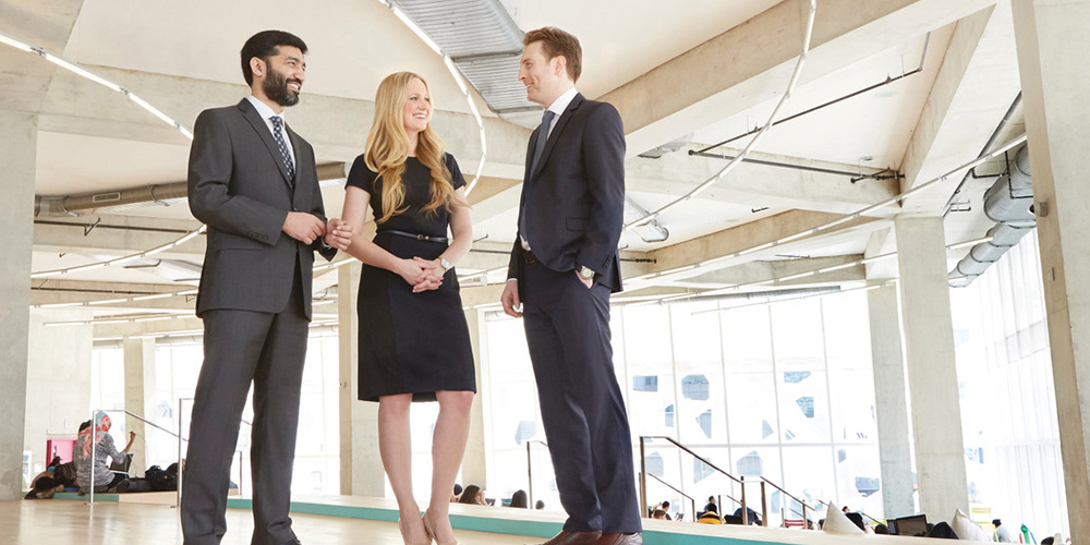 Three professional adults chatting