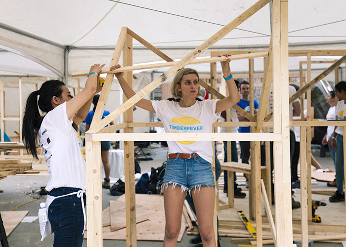 two students building a structure for a competition