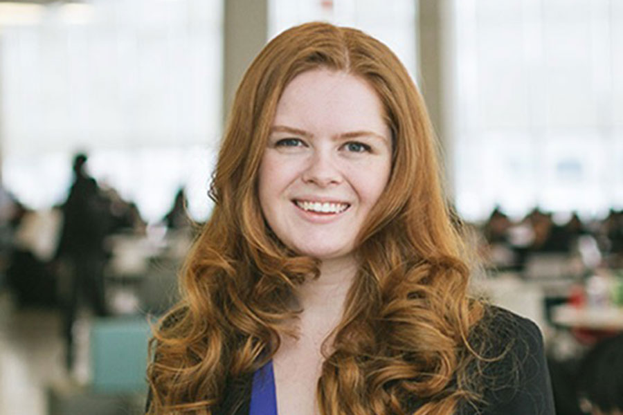 Vanessa Van Deck smiling in a busy study room