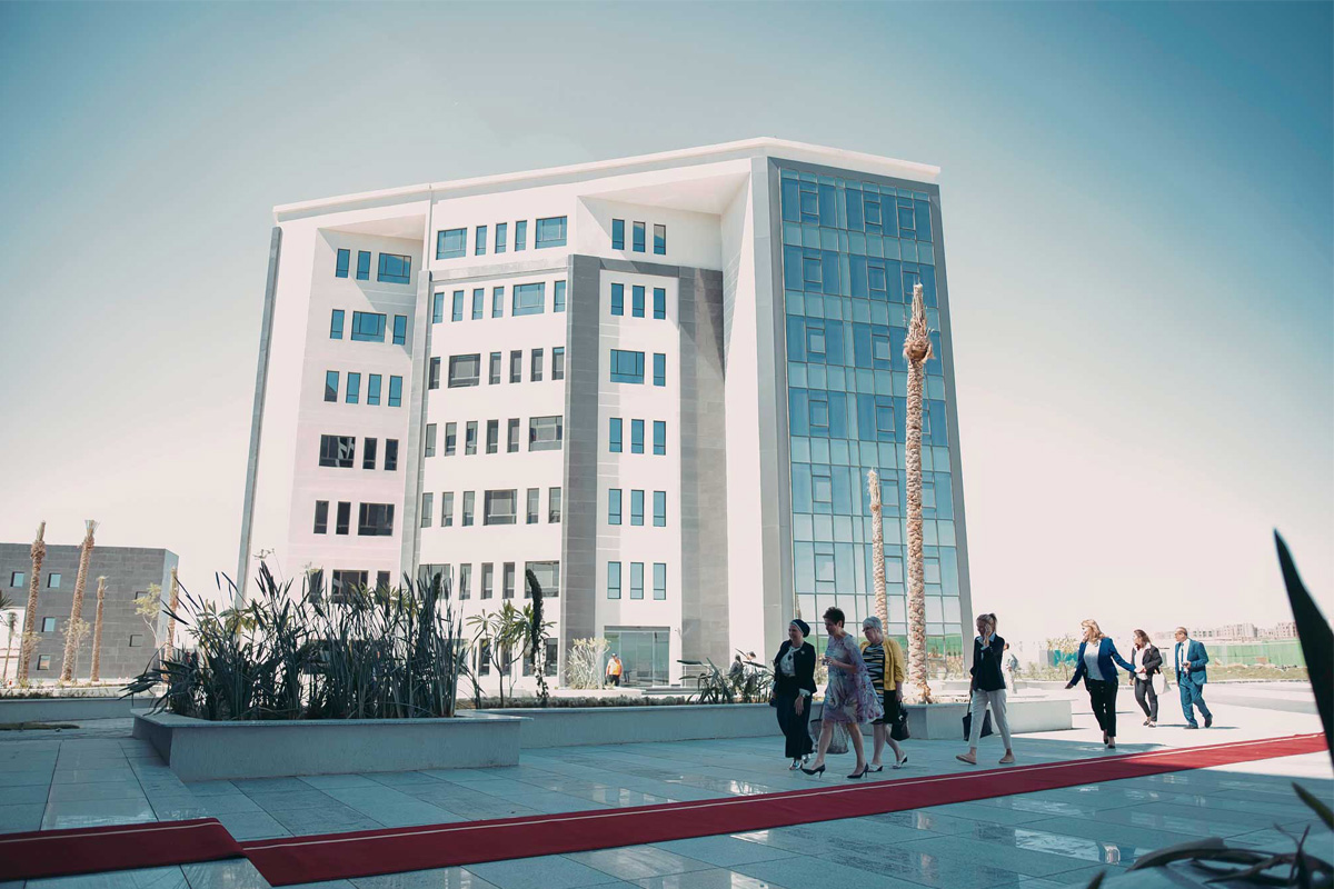 Rendering of one of the Toronto Metropolitan University Cairo Campus' buildings and a group of people walking nearby