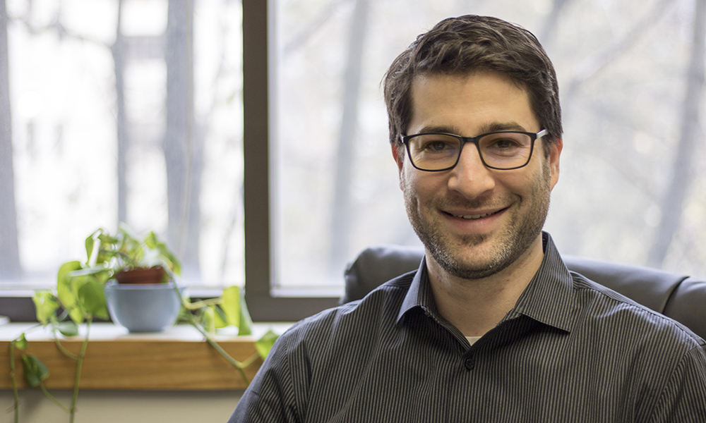 Dr. Seth Dworkin smiles in his office