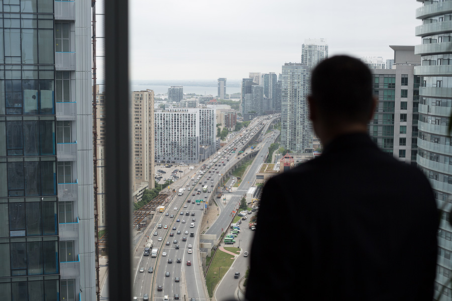A man looks out over a busy highway