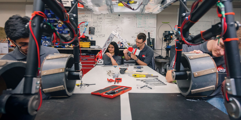 Dr. Puren Yang looking at a research project in robotics