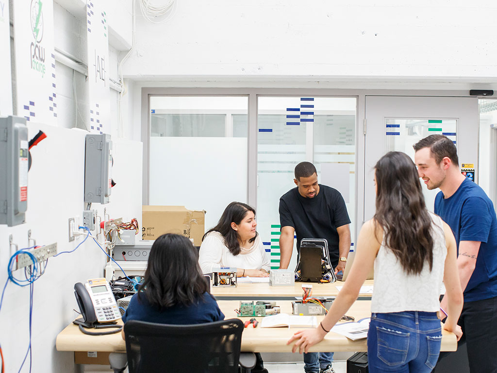 A group of five students collaborating on a project