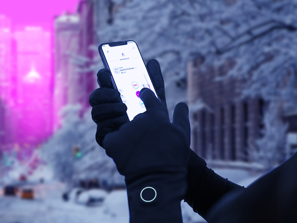 PErson wearing black Quanta Vici gloves programs them using a smartphone applicaion