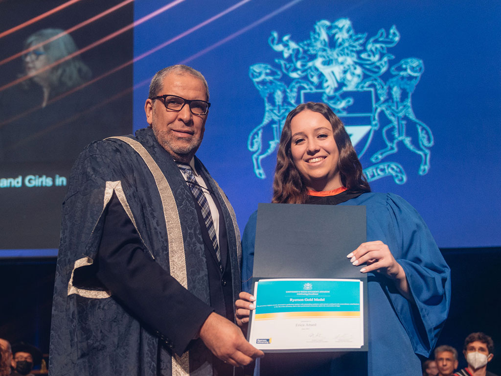 Erics Attard smiling at graduation with President Lachemi 