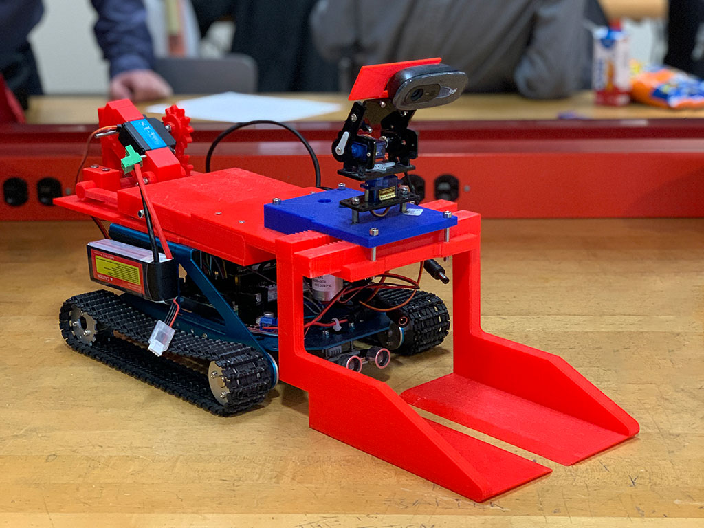 A red prototype of a robot gutter guster designed by the RED award-winning computer engineering team