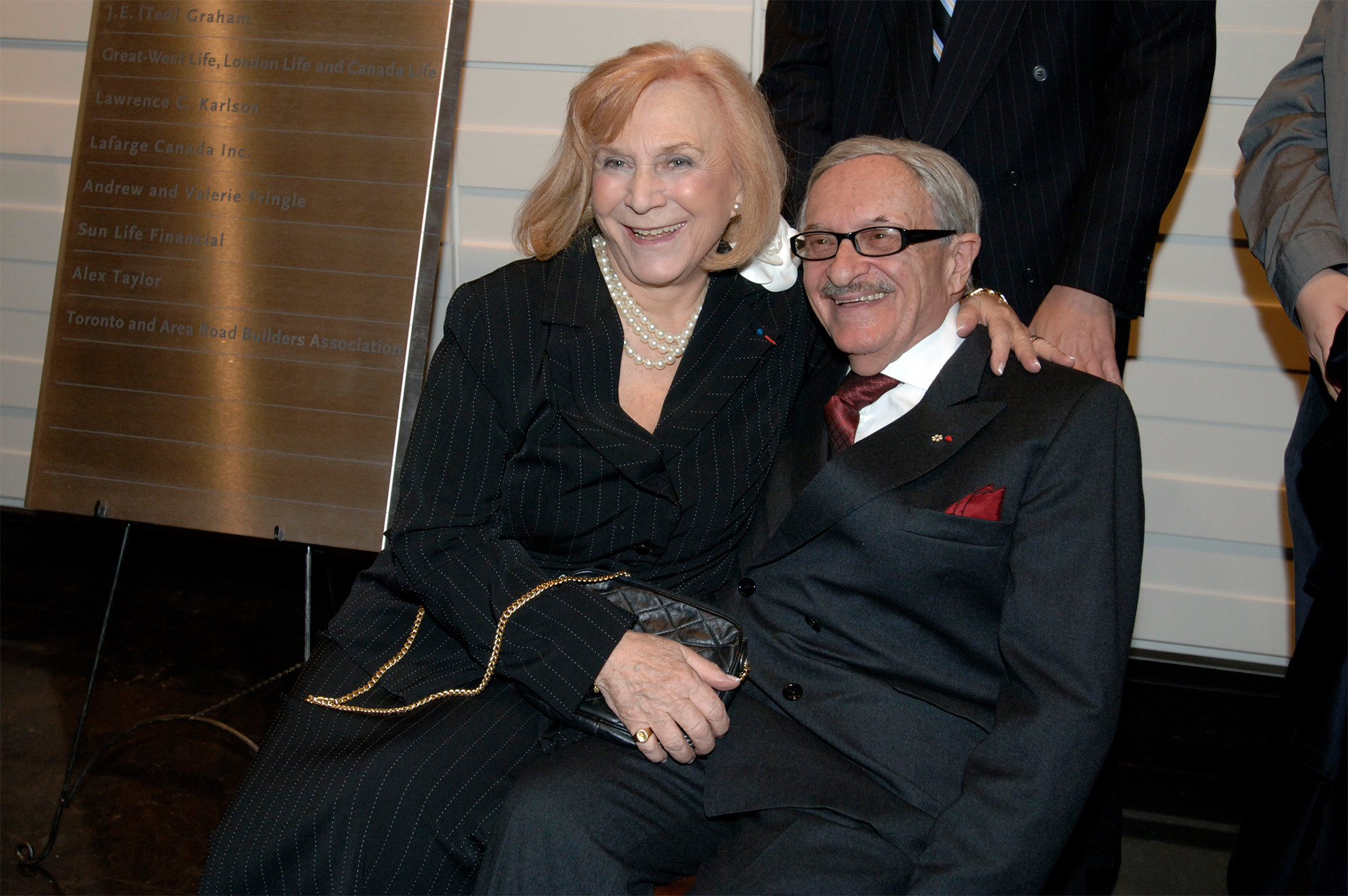 Helen and George Vari sitting together and smiling.