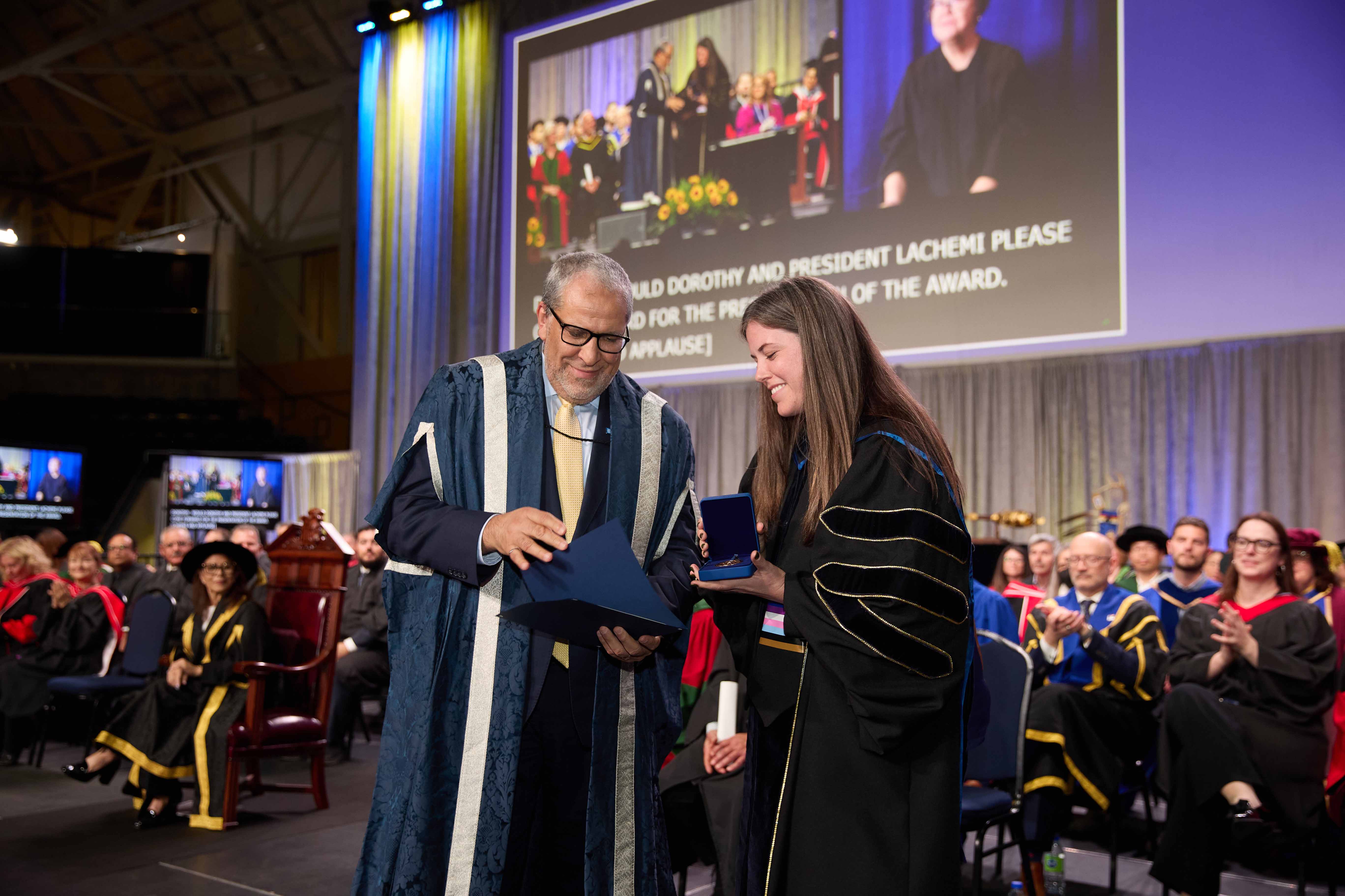 Johns receiving the Governor General’s Gold Medal award from Dr. Mohamed Lachemi, president and vice-chancellor of Toronto Metropolitan University.