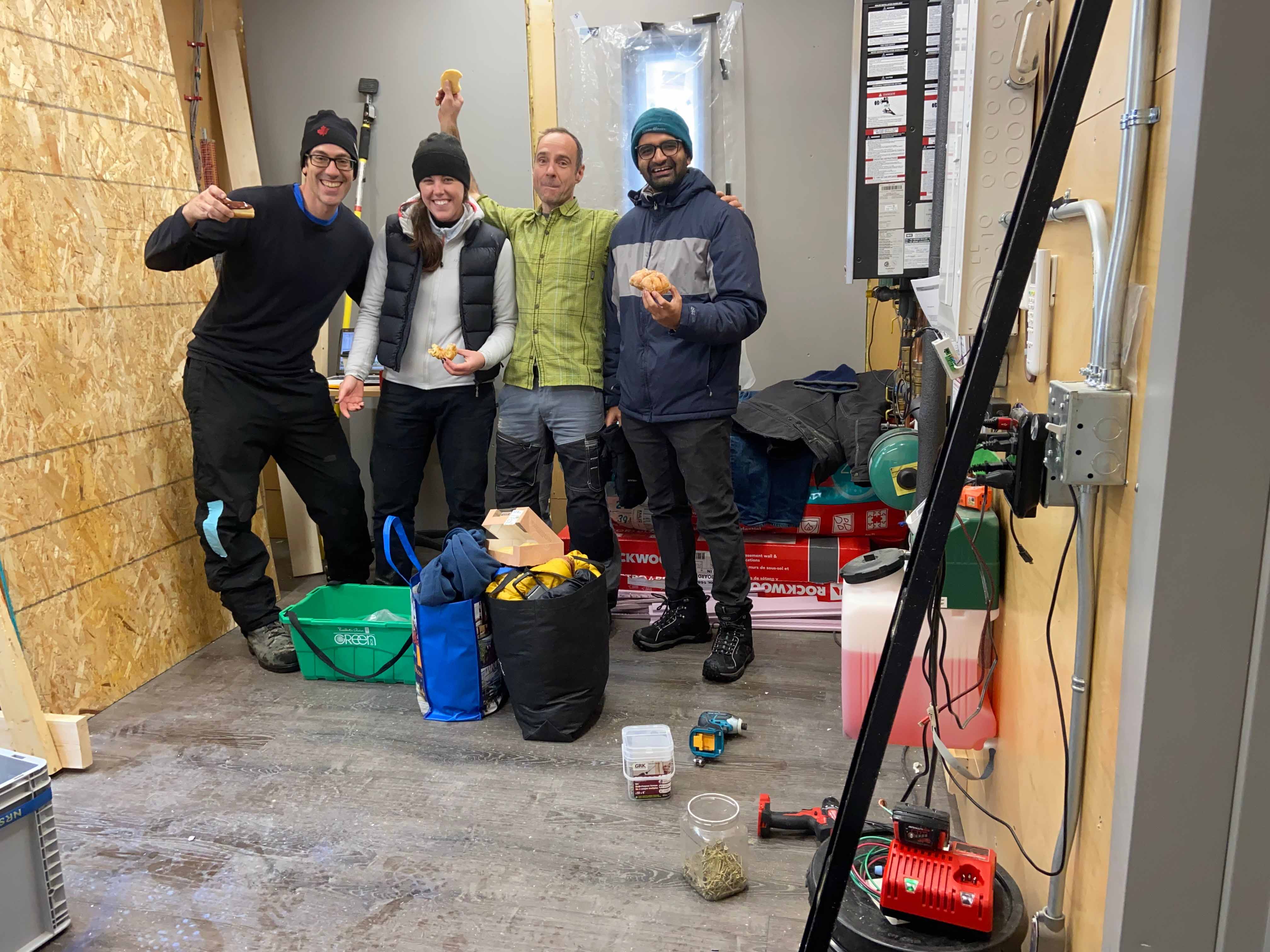 Johns enjoying a snack break while building a research hut alongside professor Russell Richman, Yash Vyas and Greg Labbé.