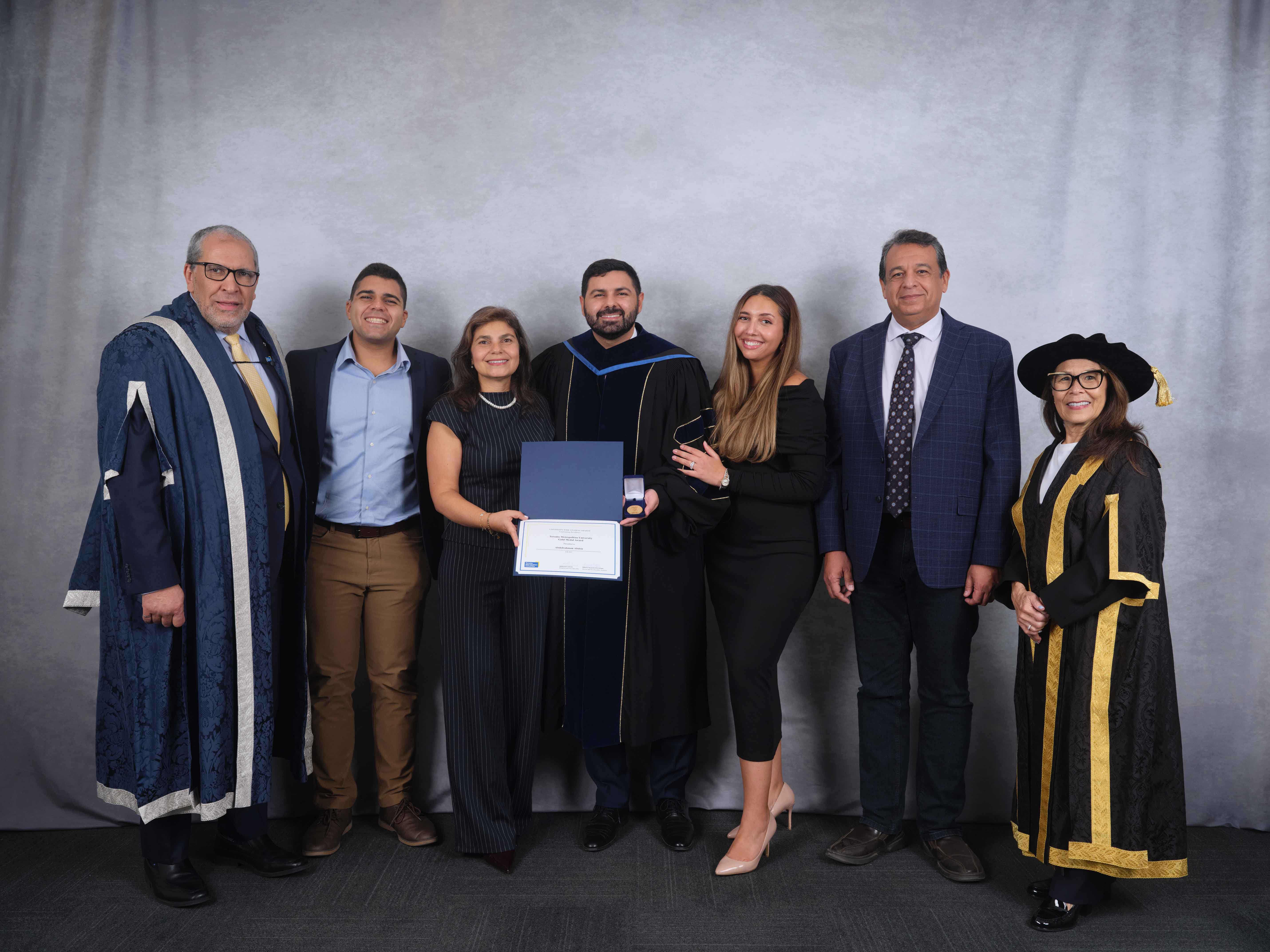 Abdou receiving the Gold Medal Award alongside his family, as well as president and vice-chancellor of Toronto Metropolitan University, Dr. Mohamed Lachemi, and chancellor Donette Chin-Loy Chang. 