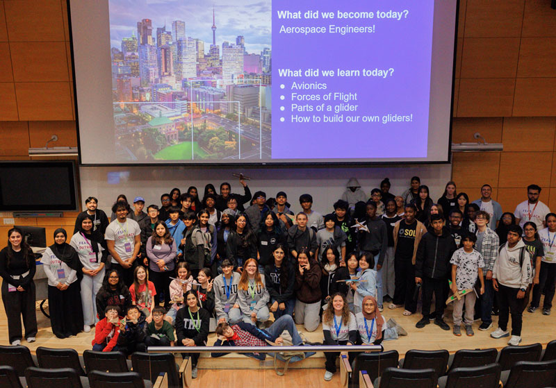 Group of smiling TMU Engineering Outreach ambassadors and student participants. 