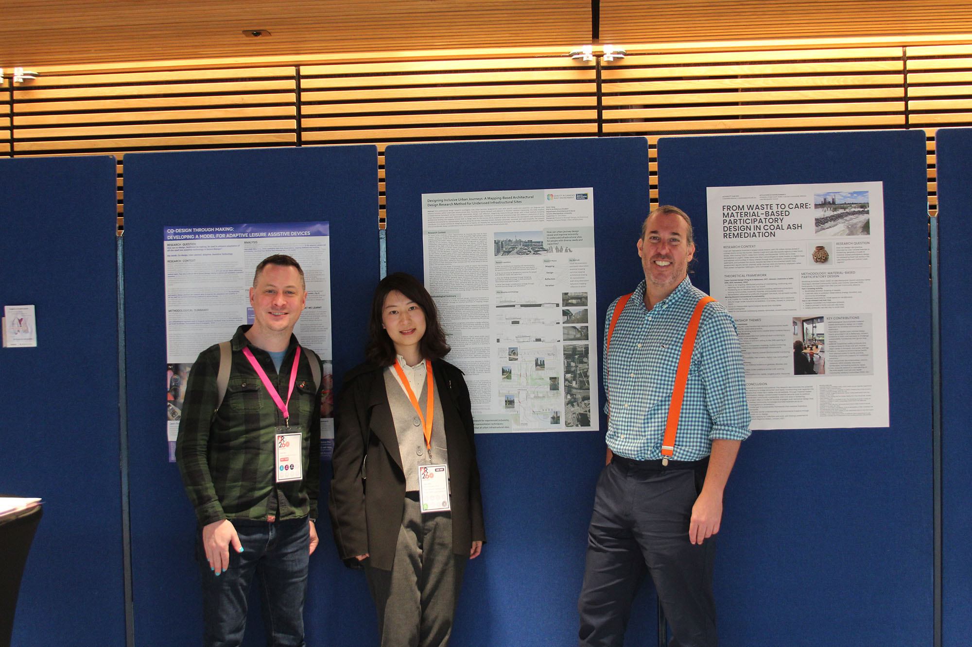 Colin Gray, Yaxin Jiang and Justin Sacks standing and smiling together at DRS conference.