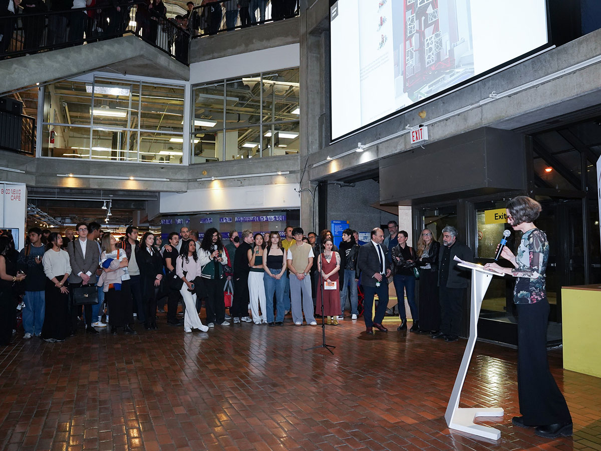 Lisa Landrum speaking at podium for the DAS BASH, a 75th anniversary celebration for Toronto Metropolitan University’s Department of Architectural Science.