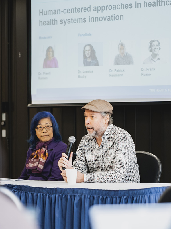 Dr. Patrick Neumann speaking on a conference panel.