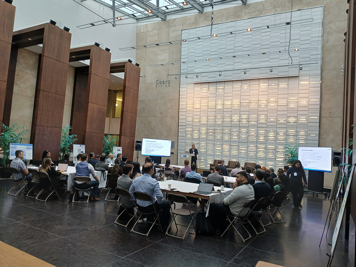 John Penaranda presenting to a group of people in an auditorium.