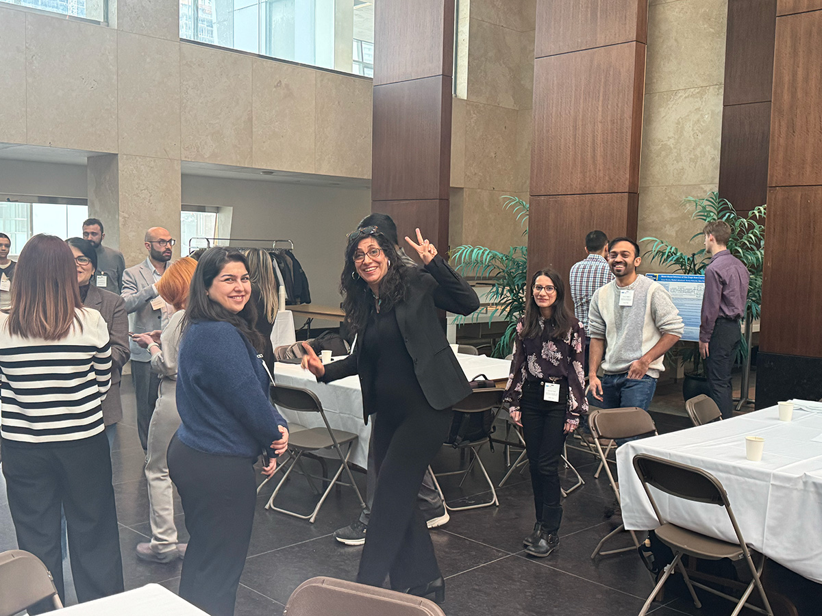 Group of smiling people exiting auditorium.