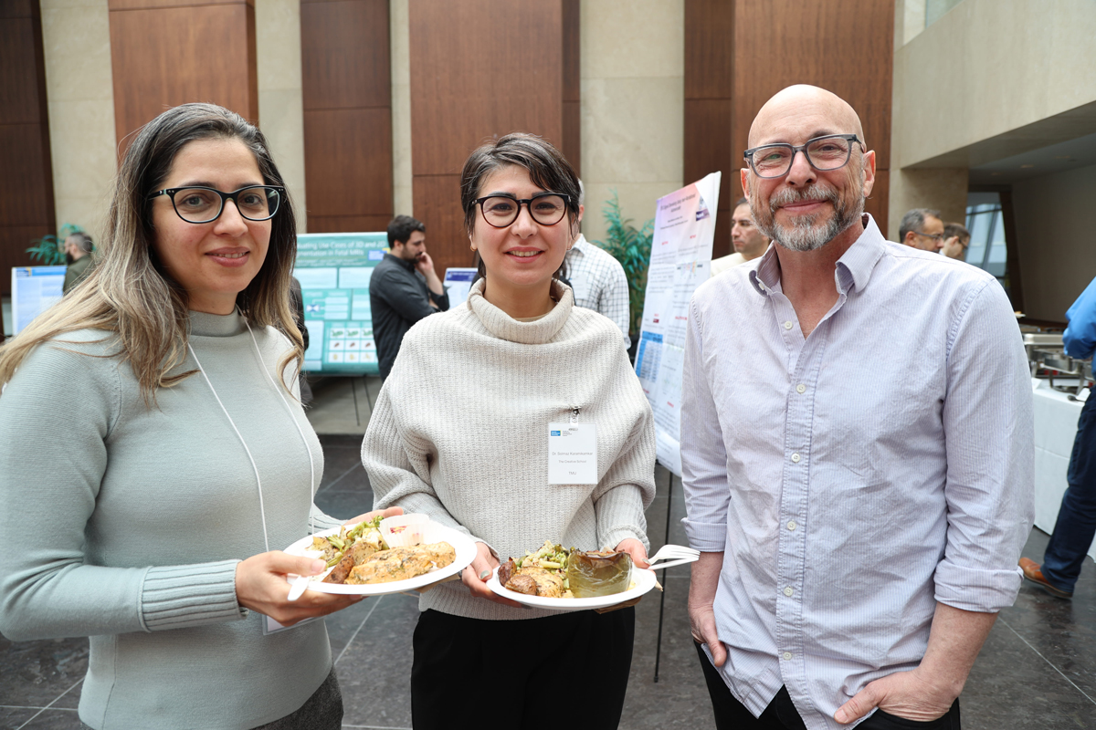 Solmaz Karamikamar and Stephen Waldman standing next to workshop attendee.
