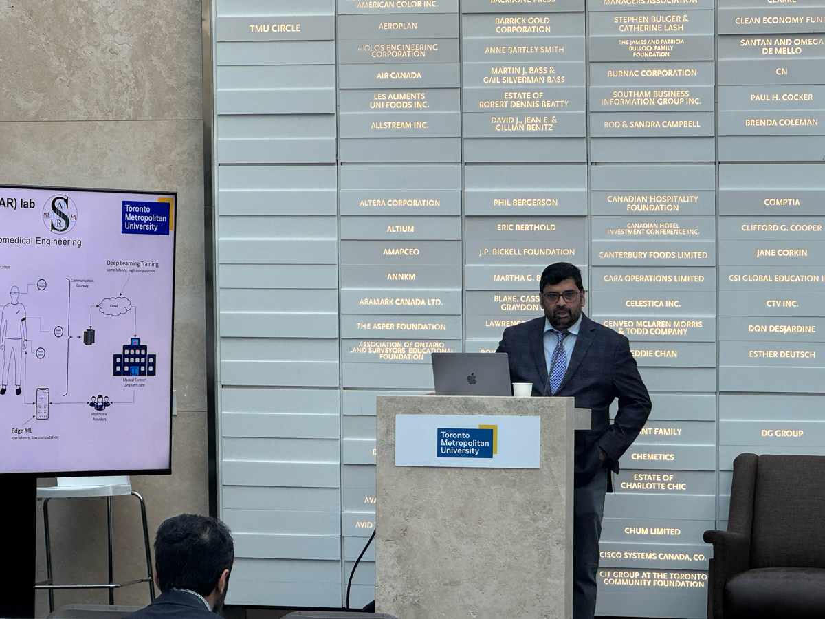 Sri Kirshnan presenting at podium.