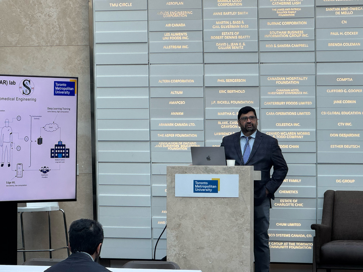 Sri Krishnan speaking at podium.
