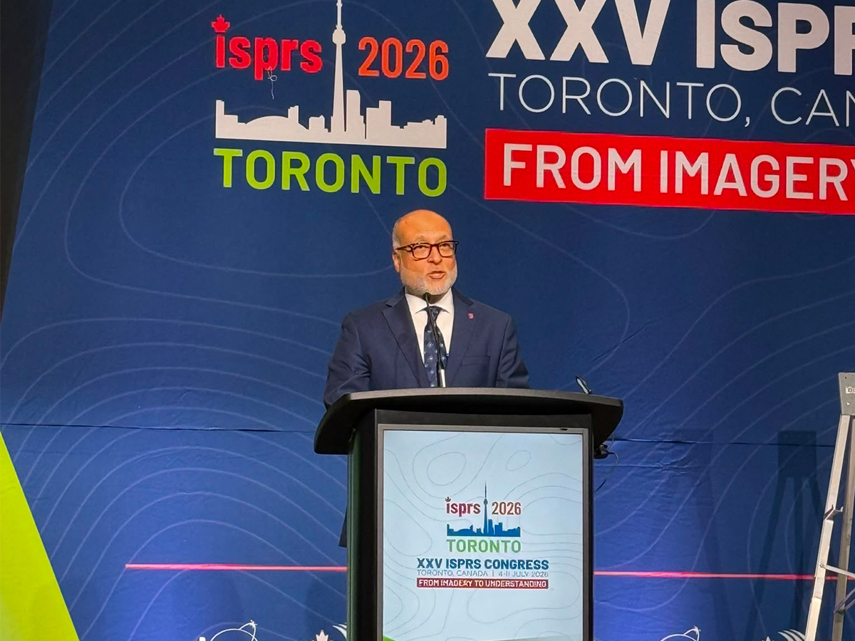 Toronto Metropolitan University’s Ahmed Shaker speaking at podium at the International Society for Photogrammetry and Remote Sensing’s General Assembly. 