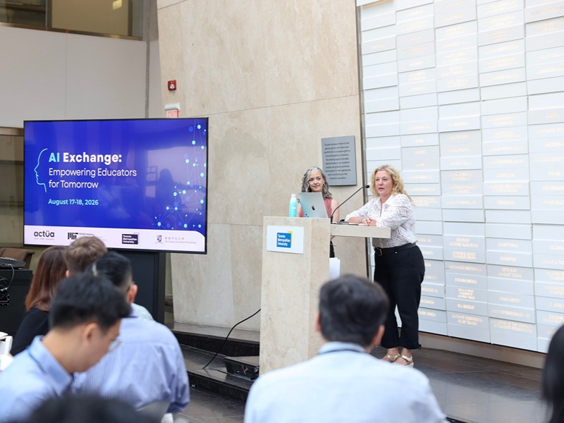Jen Carter and TMU Provost Roberta Iannacito-Provenzano speak at the podium during the AI Exchange event.