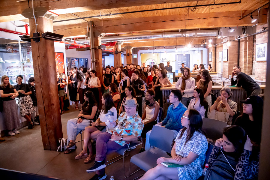 A group of attendees listening to speakers at Stripe Design. 