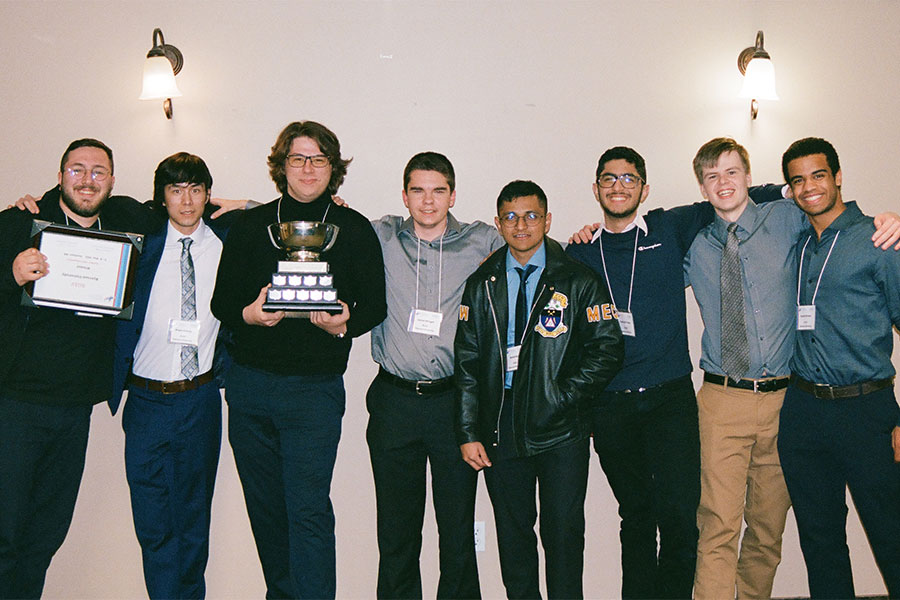 RUAV team of five male engineering students pose with their 2022 trophy and plaque