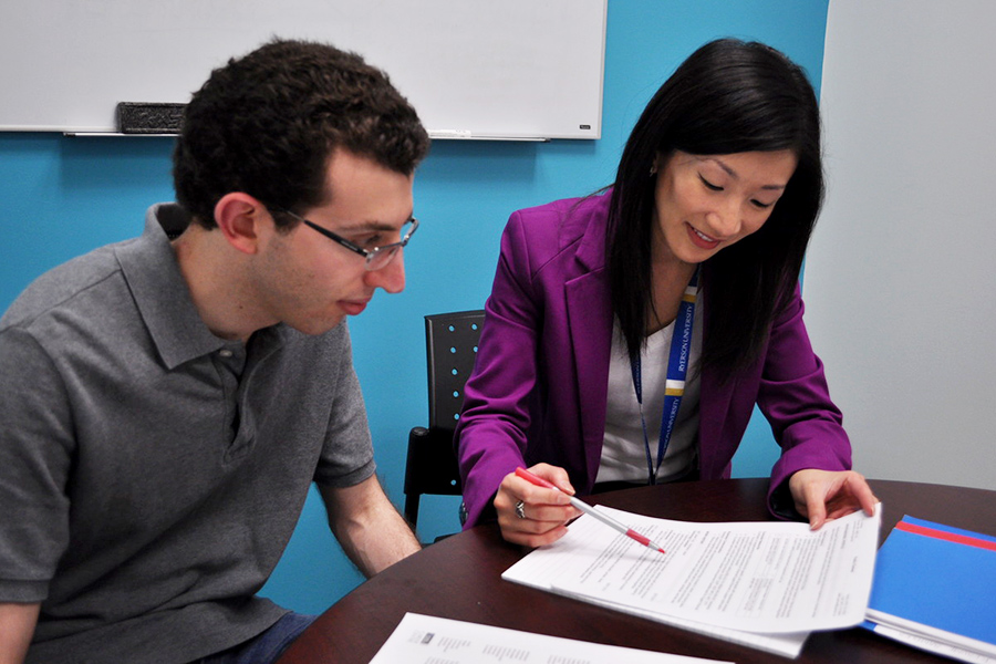 Woman points to a document as a man observes