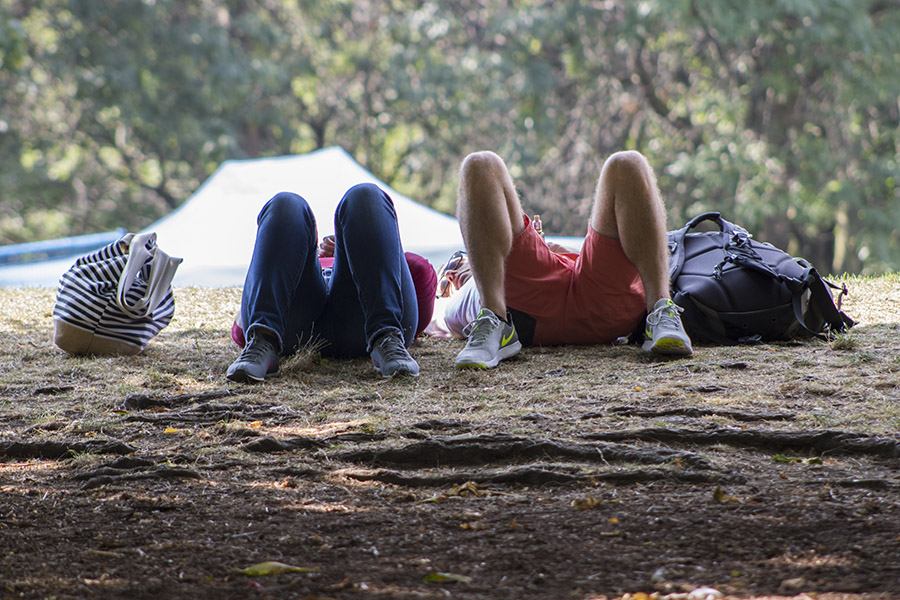 Two students laying on the ground at Kerr Hall