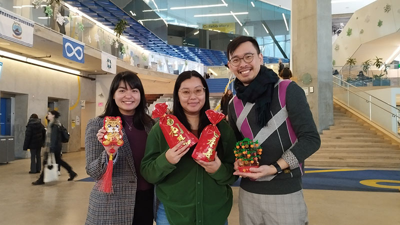 3 people posing for camera at event