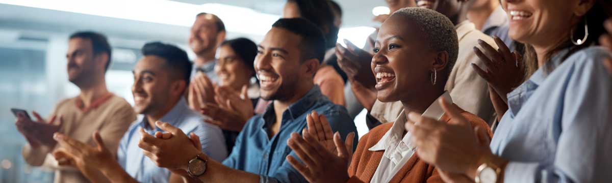 A diverse group of people applauding