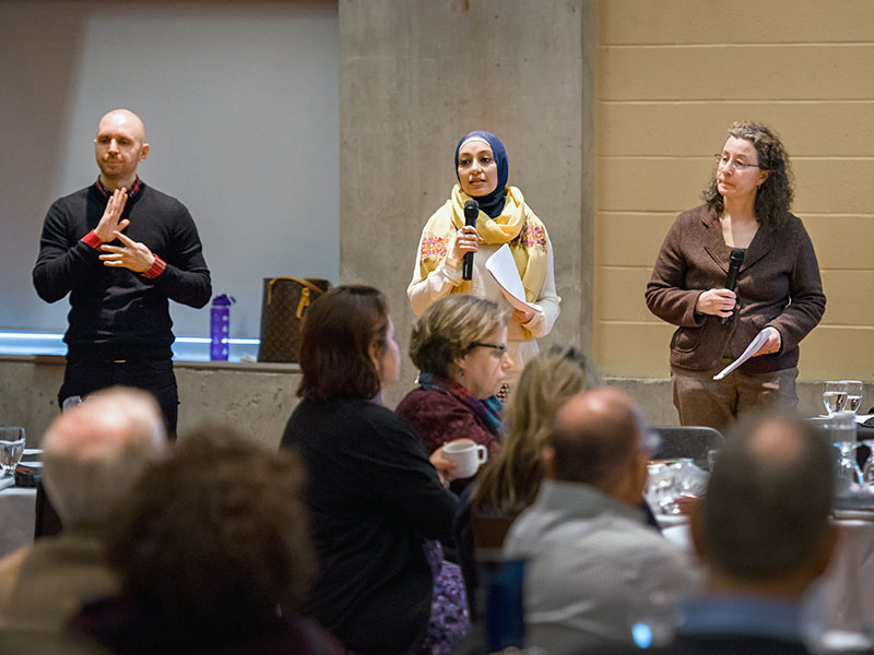 Noor Ali and Adrienne Dessel addressing the audience at a Dine and Discourse lecture on exploring intergroup dialogue