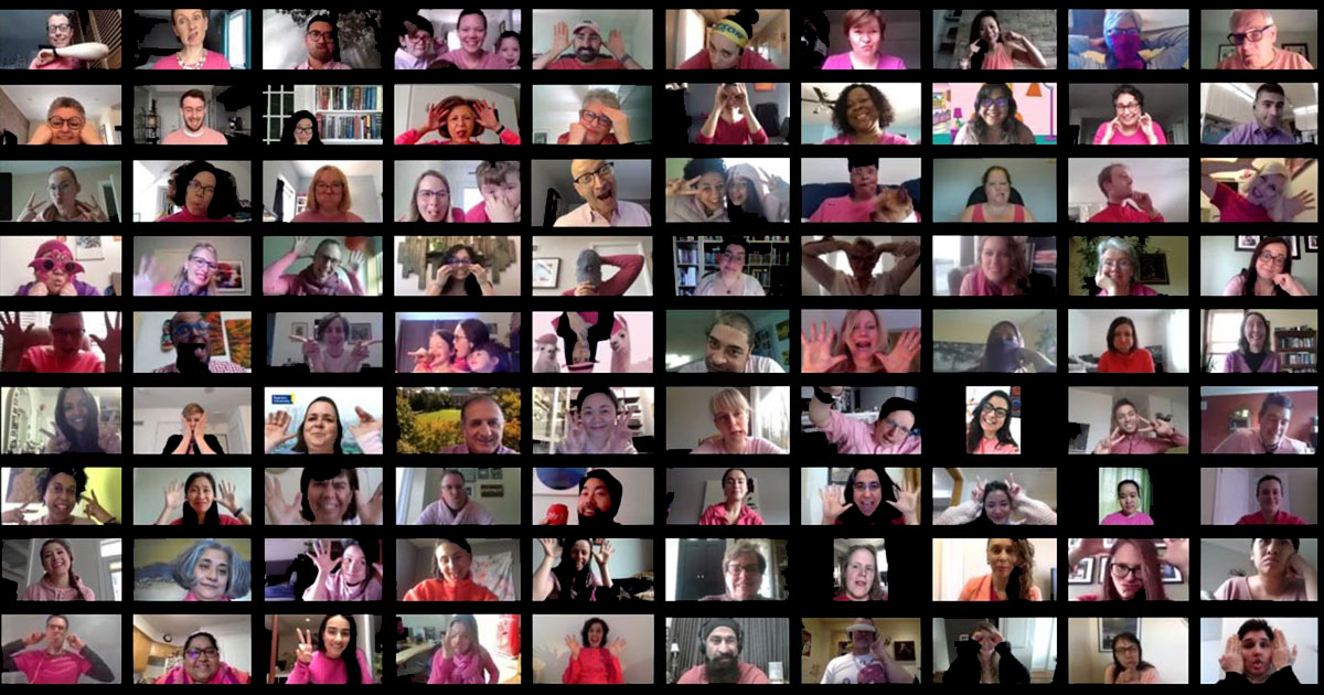 A tile view of a Zoom call with dozens of staff members in pink shirts