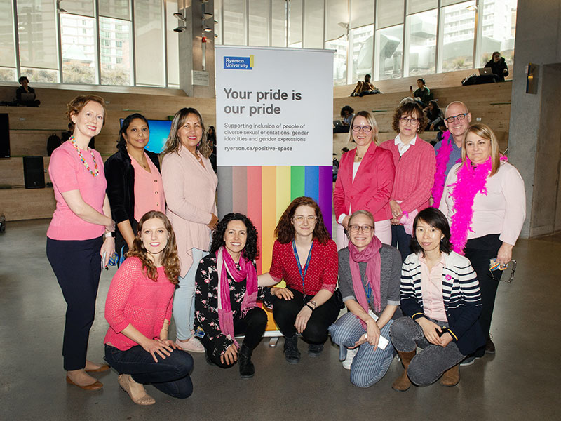 Ryerson staff members in pink shirts in the Student Learning Centre 