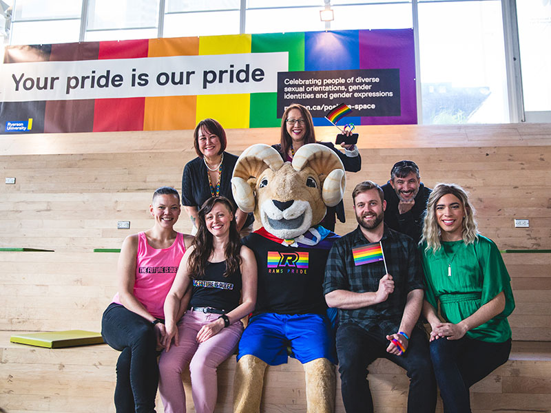 Ryerson staff members pose with Eggy the Mascot in the Student Learning Centre