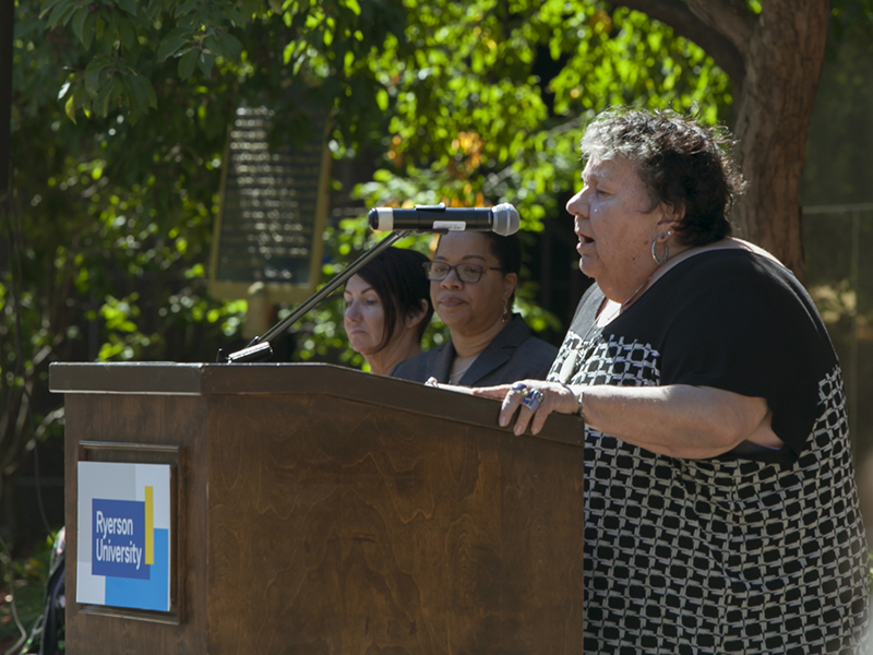 Elder Joanne Dallaire leading the opening prayer at the plaque unveiling next to the Egerton TMU statue on Gould Street 