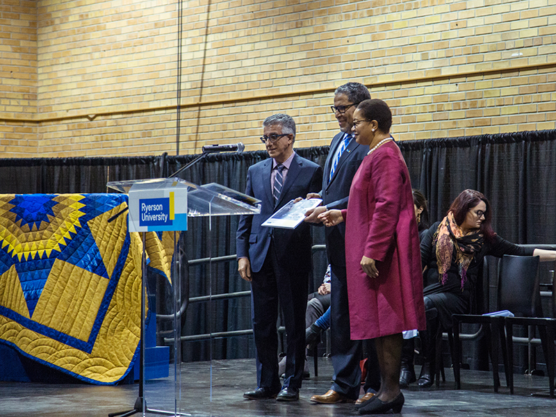 Michael Benarroch, Mohamed Lachemi and Denise O'Neil Green holding the community consultation report at the Truth and Reconciliation at TMU community celebration